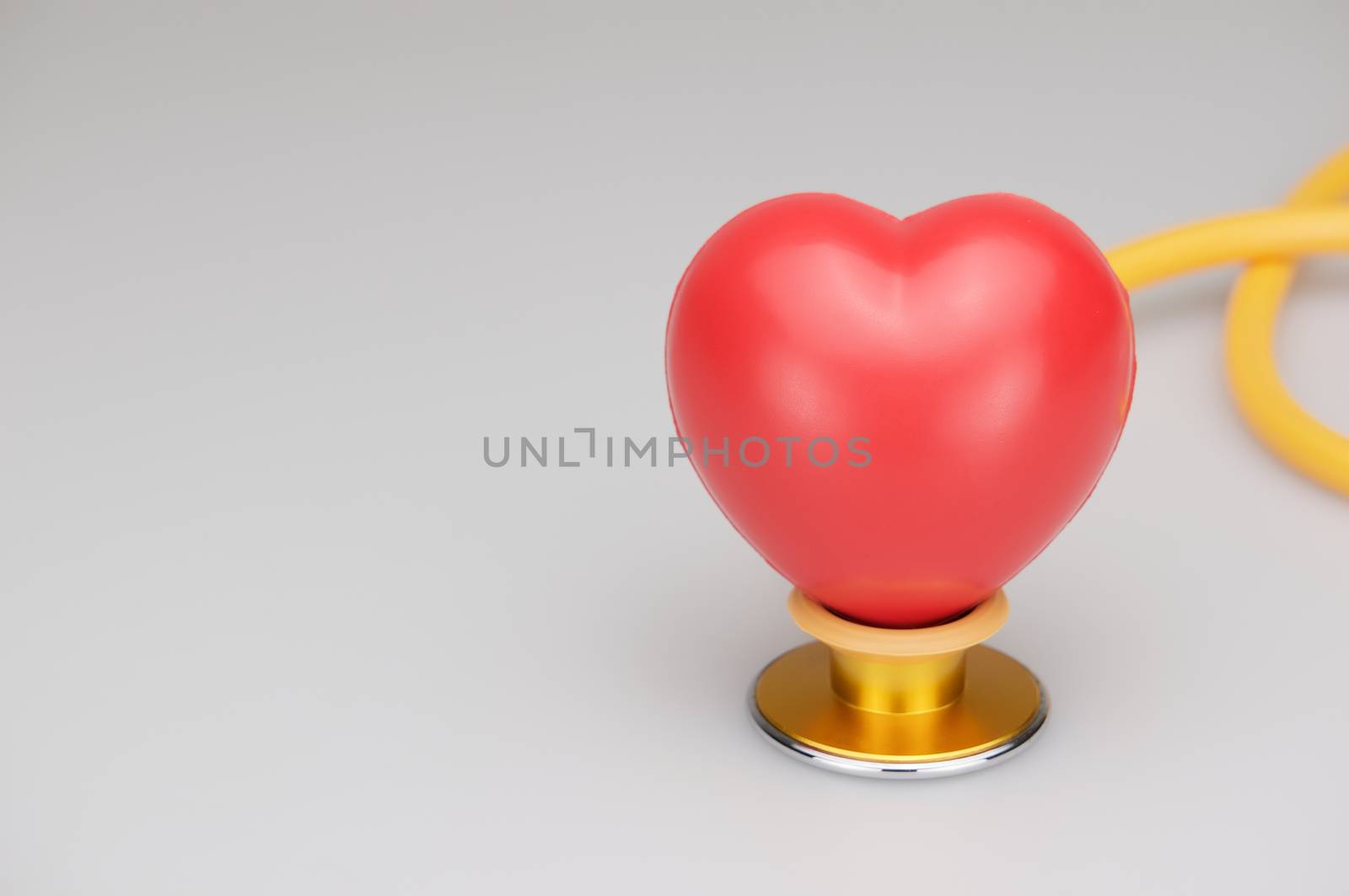 Red heart on stethoscope with white background by eaglesky