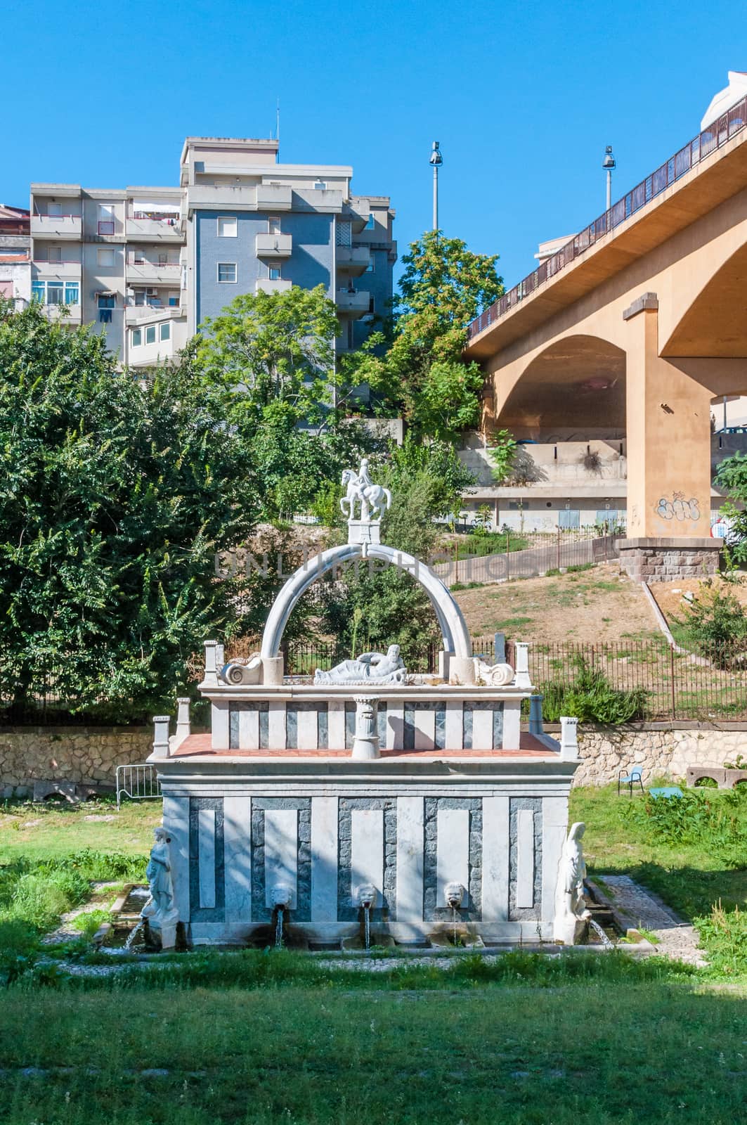 Ancient fountain in the middle of italian city