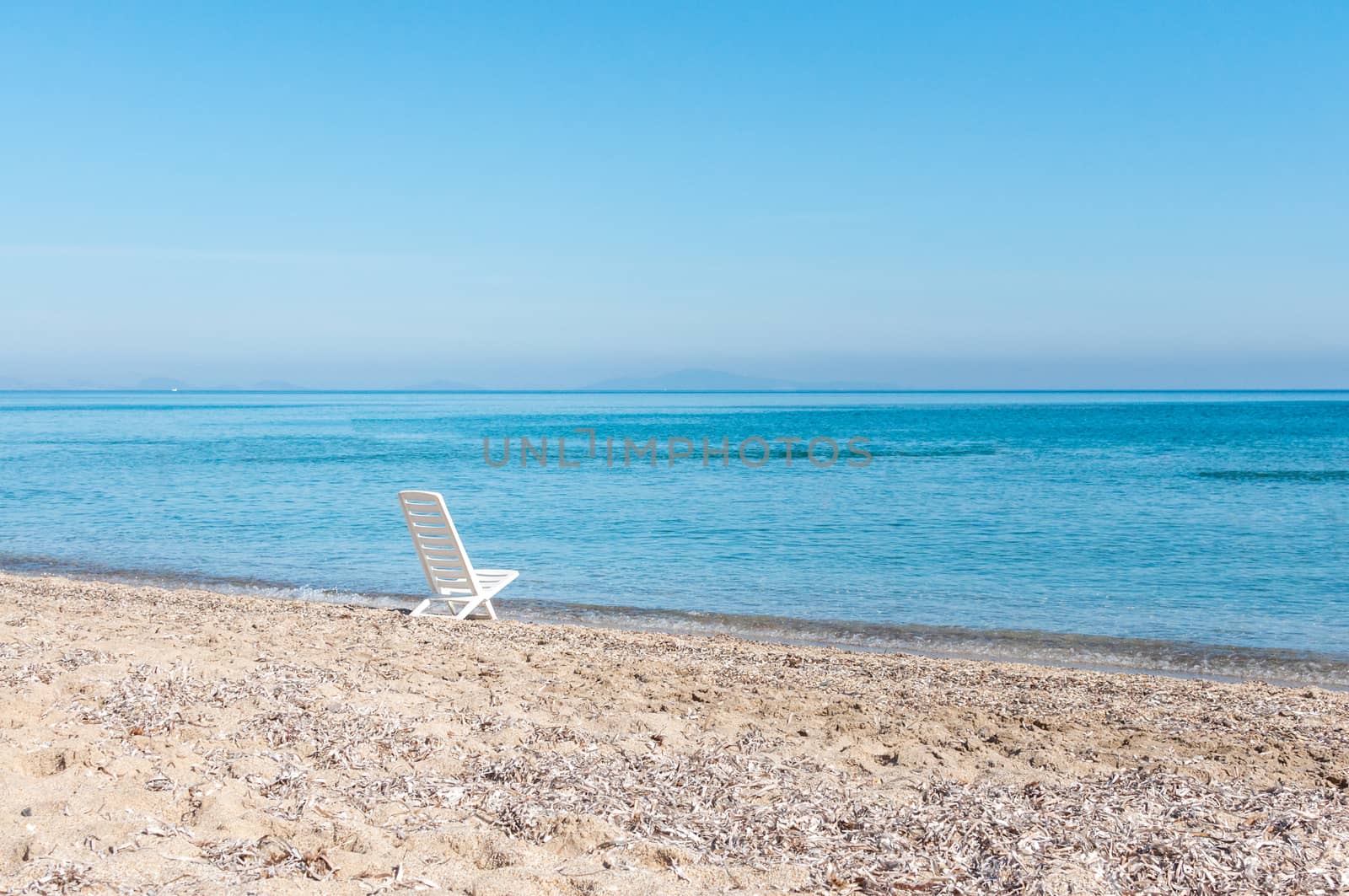 white chair on the beach by replica