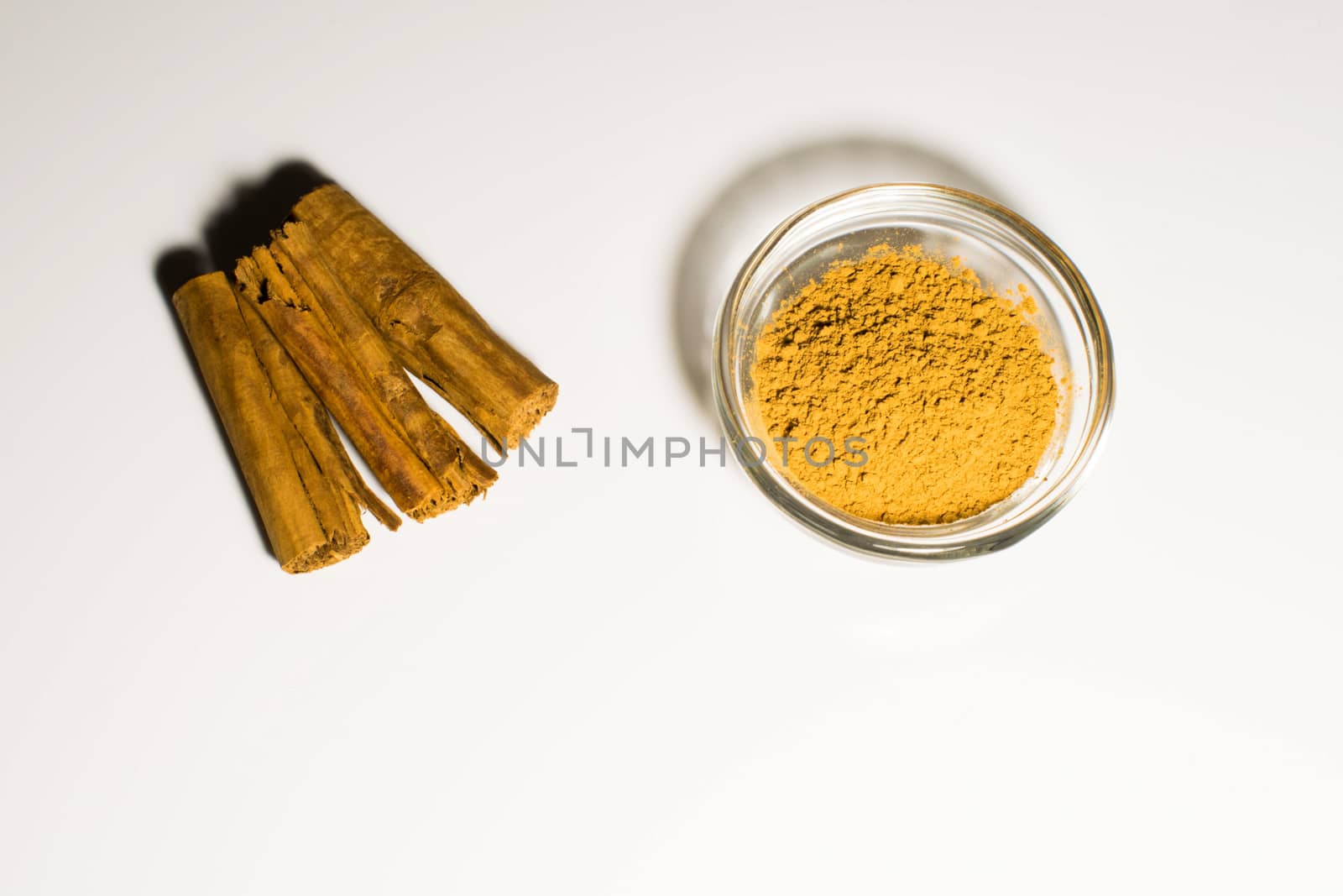 Cinnamon in two form in a white background