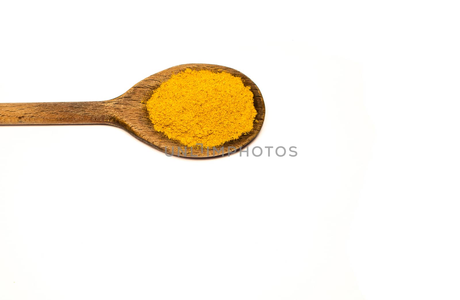 A wooden spoon with curry in a white background