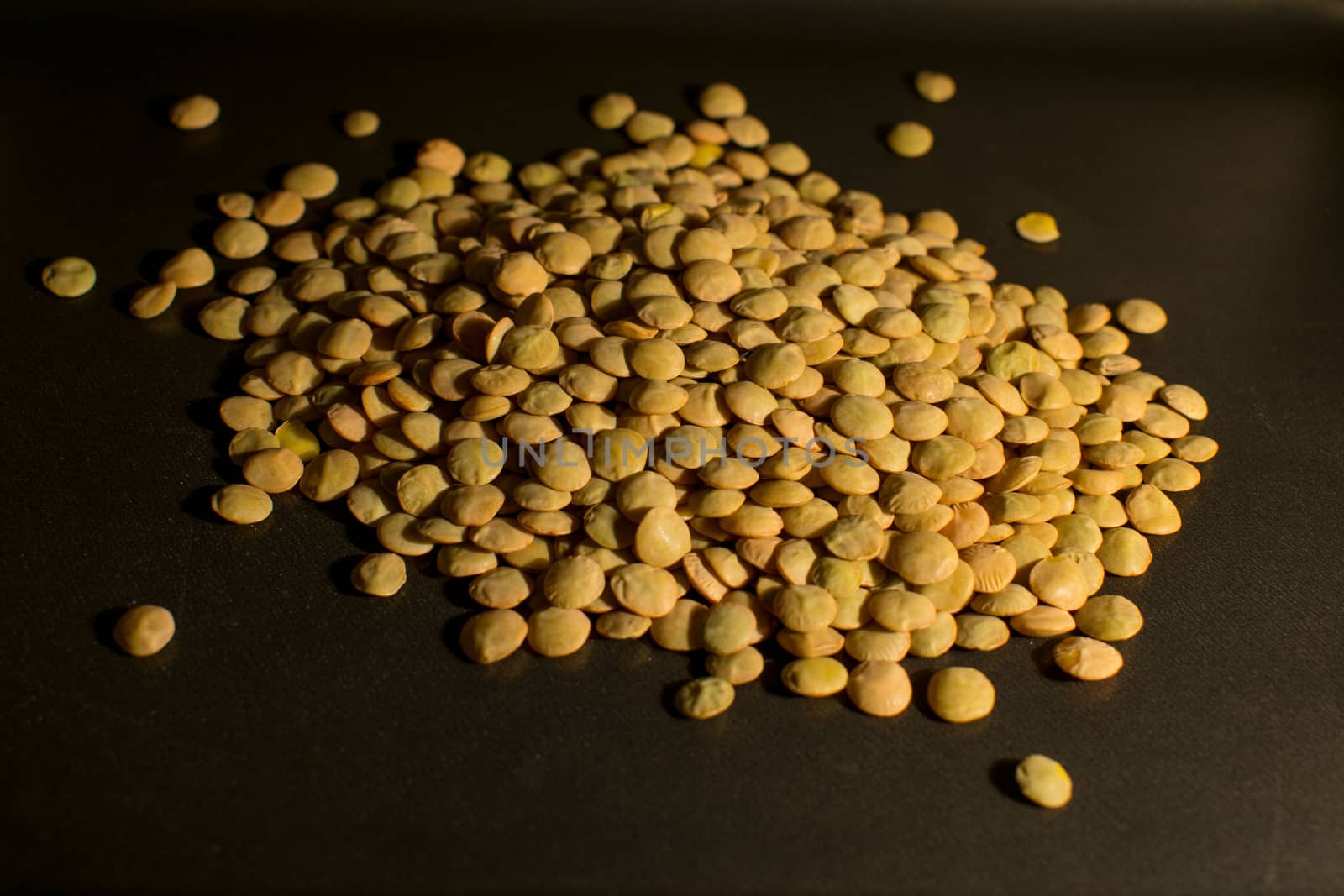 Dried lentils in a darken background