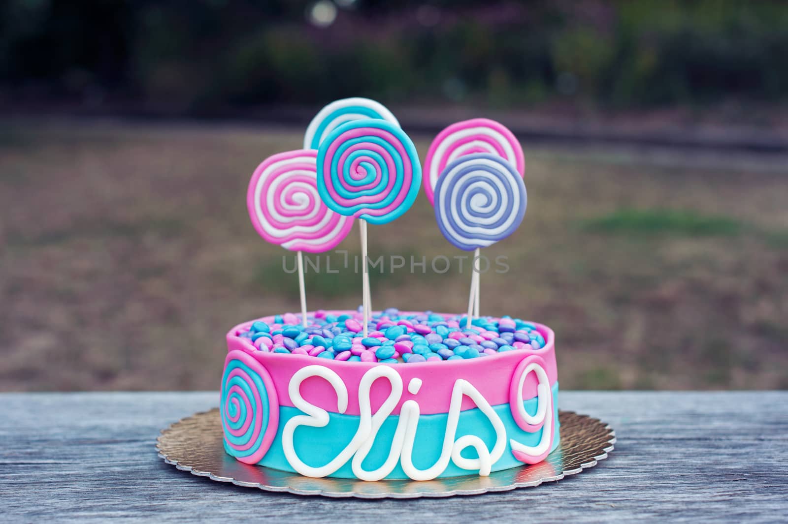 Delicious birthday cake on a table outdoor 