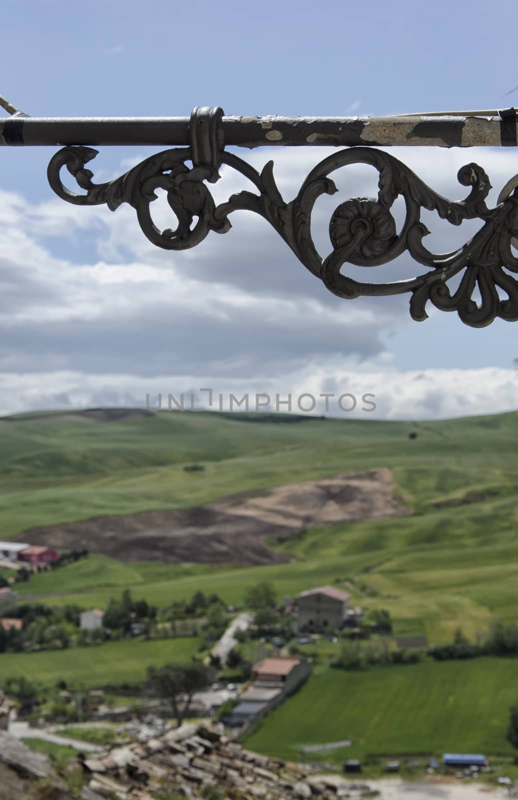 Wrought iron lamp with landscape in the background
