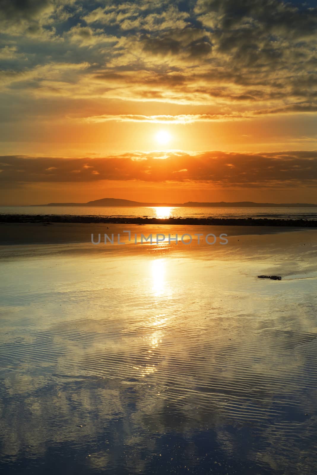 reflections at beal beach near ballybunion on the wild atlantic way ireland with a beautiful yellow sunset