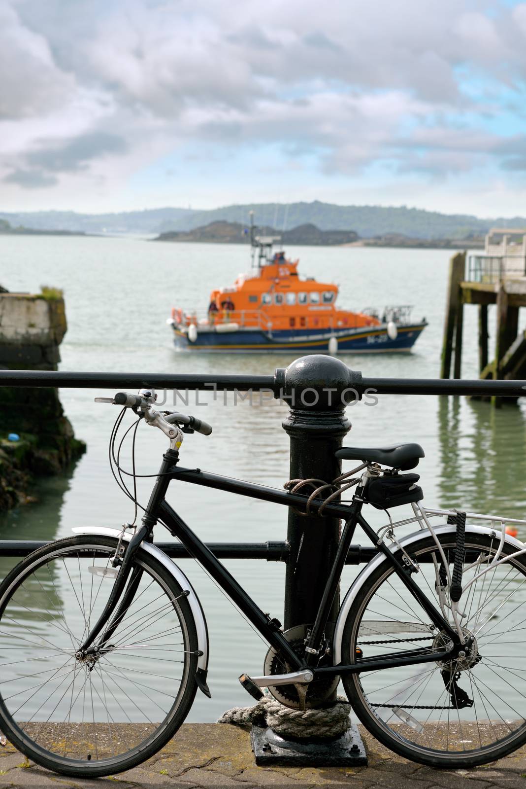rescue lifeboat in cobh harbour county cork ireland with bicycle in foreground chained to post