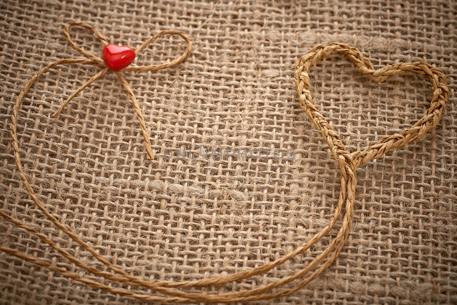 Love hearts, Valentines Day. Heart handmade, made of twine on sackcloth.  Vintage romantic style creative unusual greeting card, copyspace