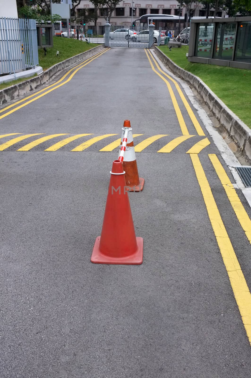 Red cones and yellow striped warning road