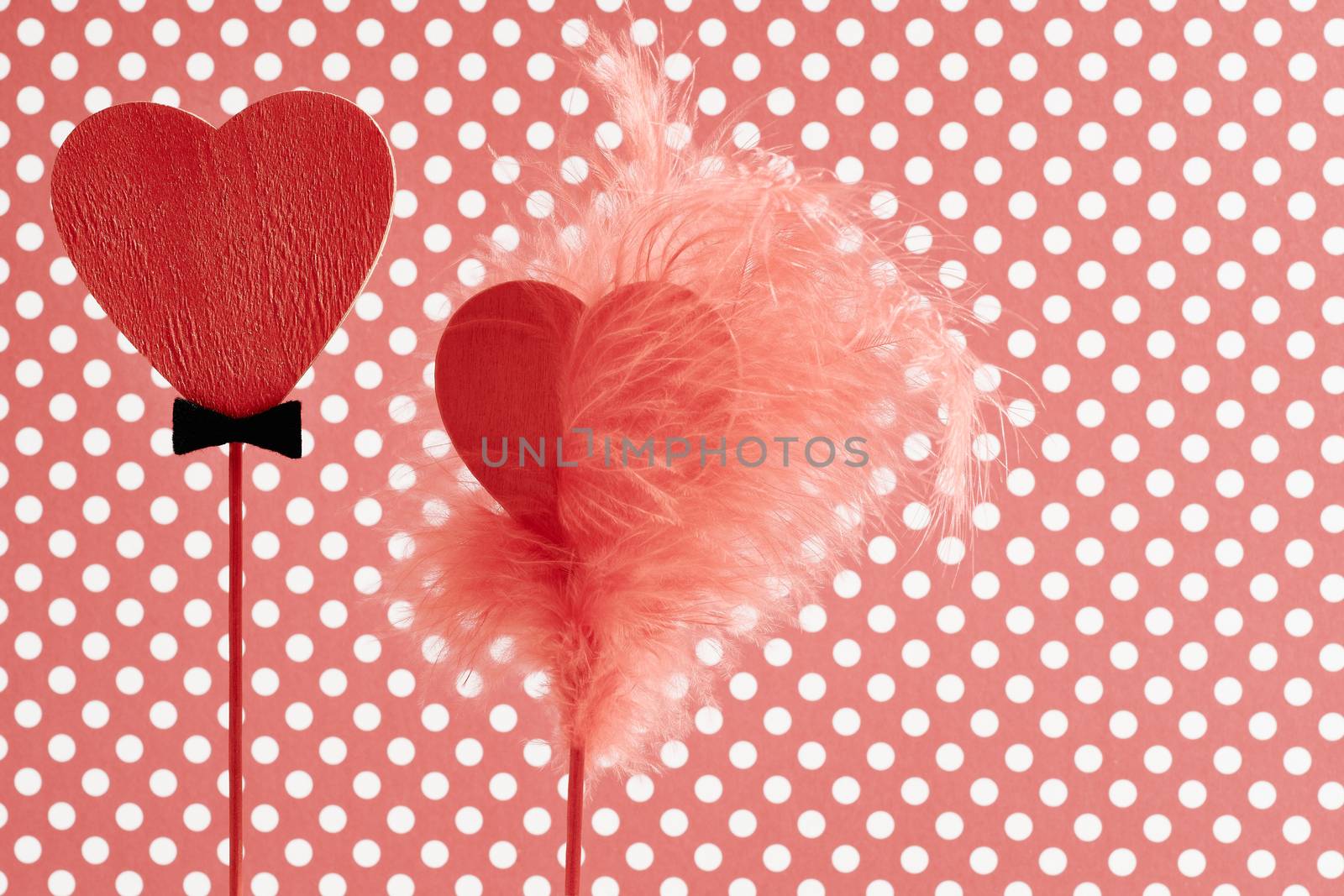 Love hearts , Valentines Day. Hearts couple made of red wood, Vintage romantic style on polka dots background. Stylish elegance decoration with feather. Retro unusual greeting card, toned, copyspace