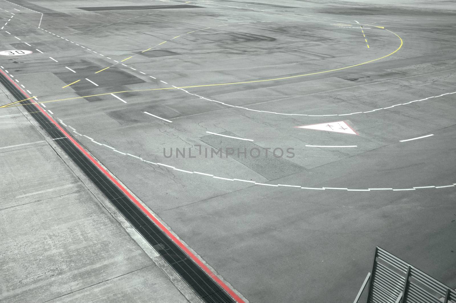 View of airport runway from window of airplane by Hepjam
