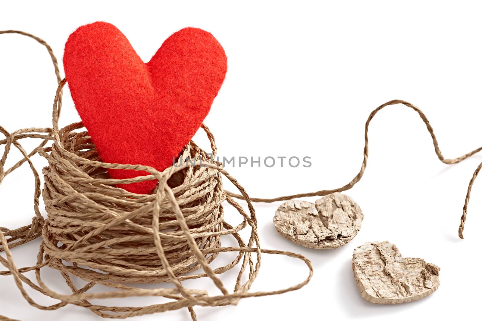 Love heart, Valentines Day. Handmade of red felt alone in nest. Vivid creative unusual greeting card, copyspace. Romantic, isolated on white