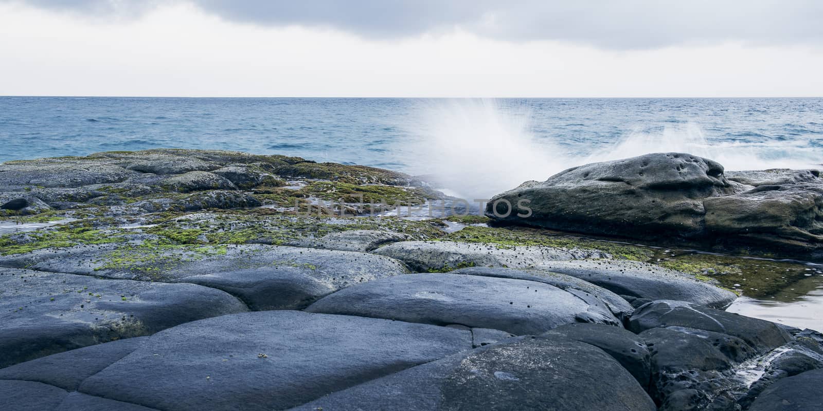 Rocks and waves at Point Cartwright beach in the afternoon. Sunshine Coast, Queensland.