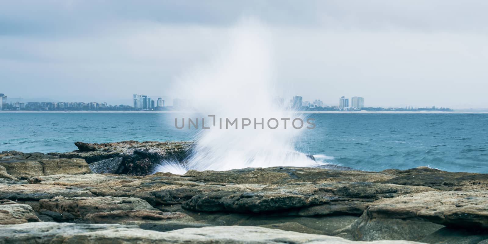 Rocks and waves at Point Cartwright beach in the afternoon. Sunshine Coast, Queensland.