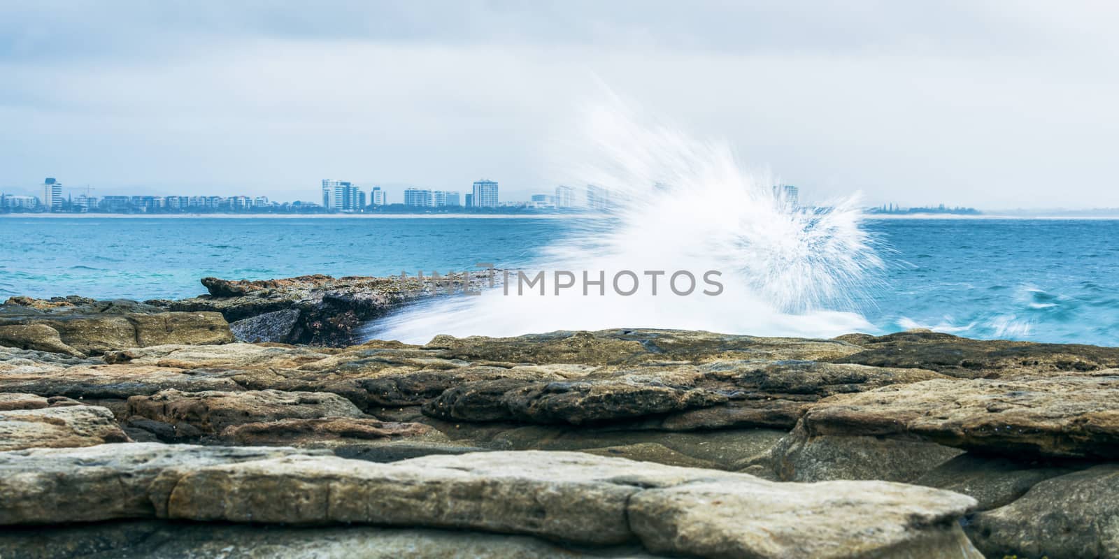 Rocks and waves at Point Cartwright beach in the afternoon. Sunshine Coast, Queensland.