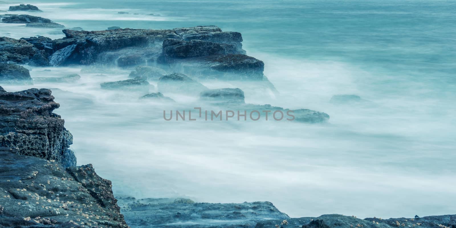 Rocks and waves at Point Cartwright beach in the afternoon. Sunshine Coast, Queensland.