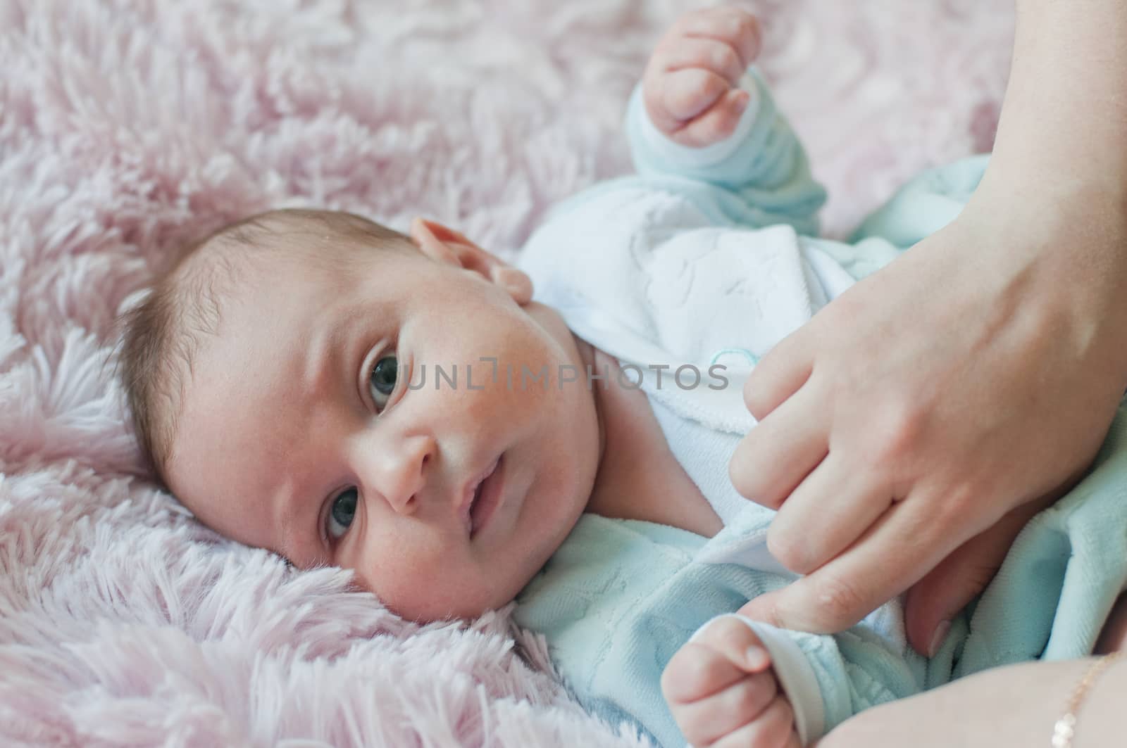 baby and woman hands wearing him
