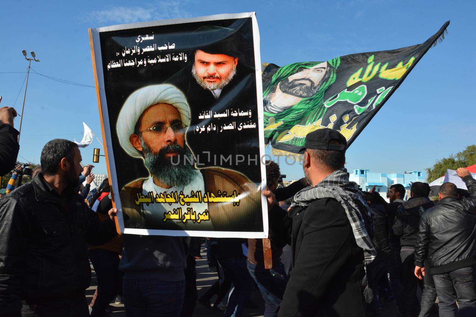 IRAQ, Baghdad: Demonstrators hold banners at a demonstration on January 4, 2016, in Baghdad against the killing of cleric Nimr al-Nimr.Saudi authorities executed Shia cleric Nimr al-Nimr on Saturday, along with 46 others, sparking outrage across the world.