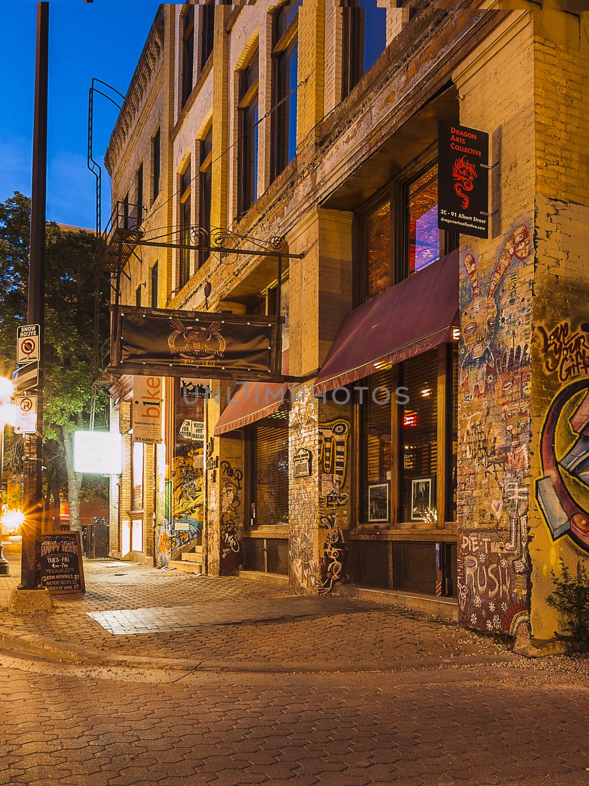 Winnipeg. Evening street. Old building with graffiti on the walls. Frame vertical. Canada.