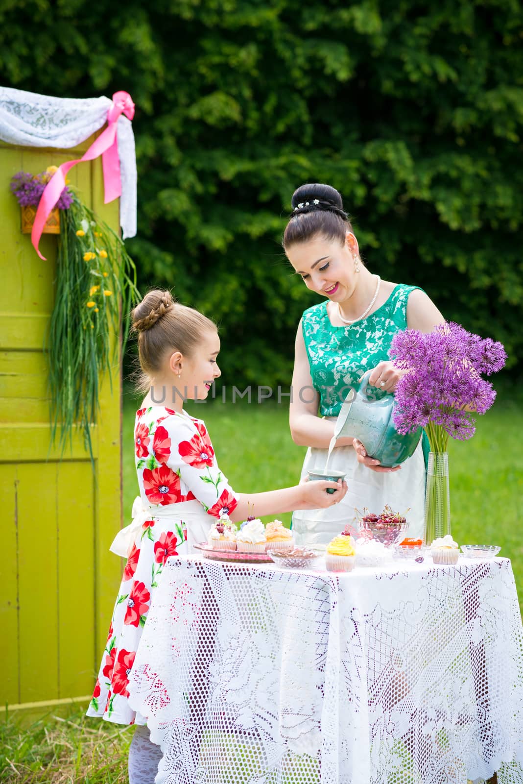 Mother and daughter cooking cupcakes by okskukuruza