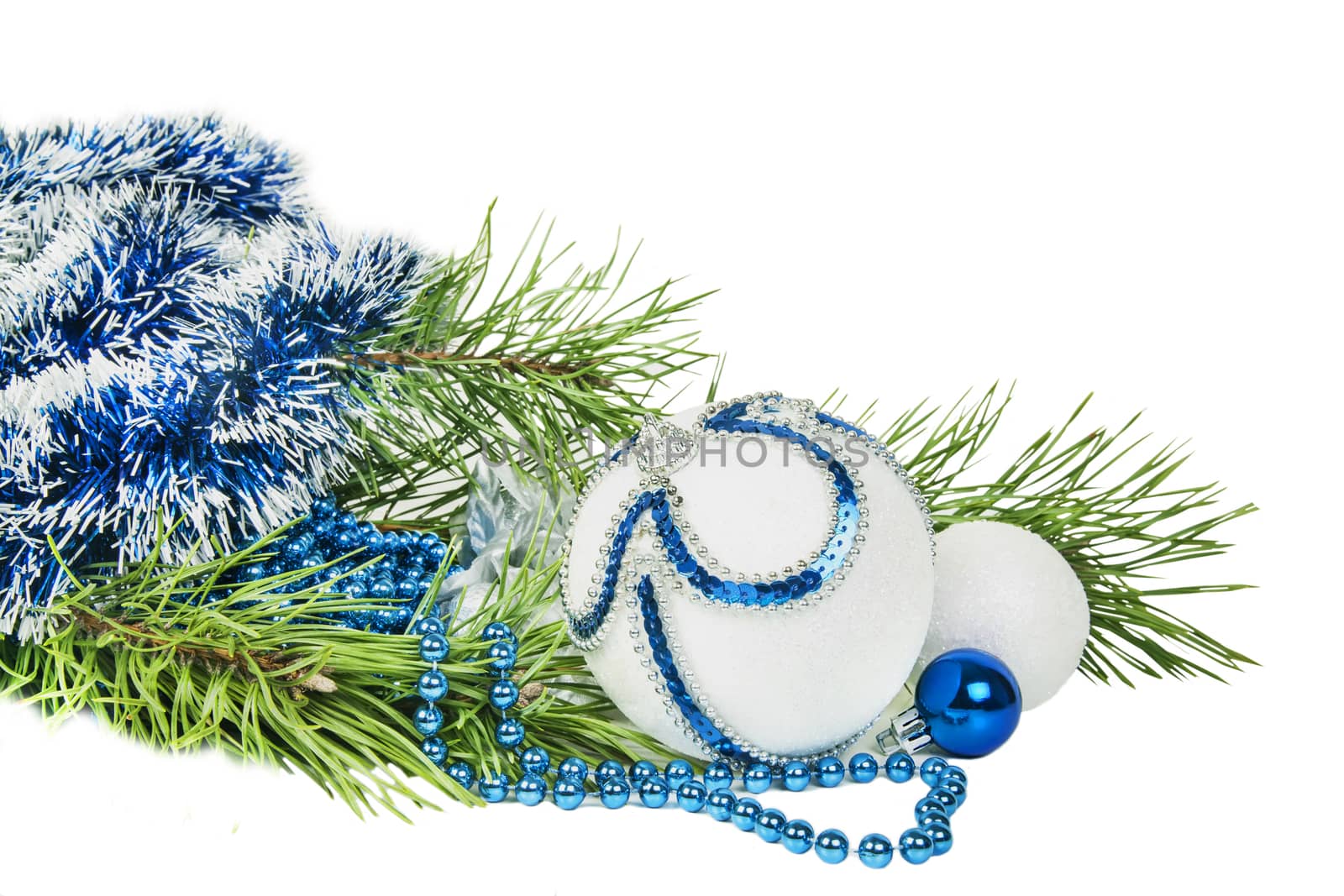 Christmas tree branch and blue ball with white glitter isolated  by RawGroup