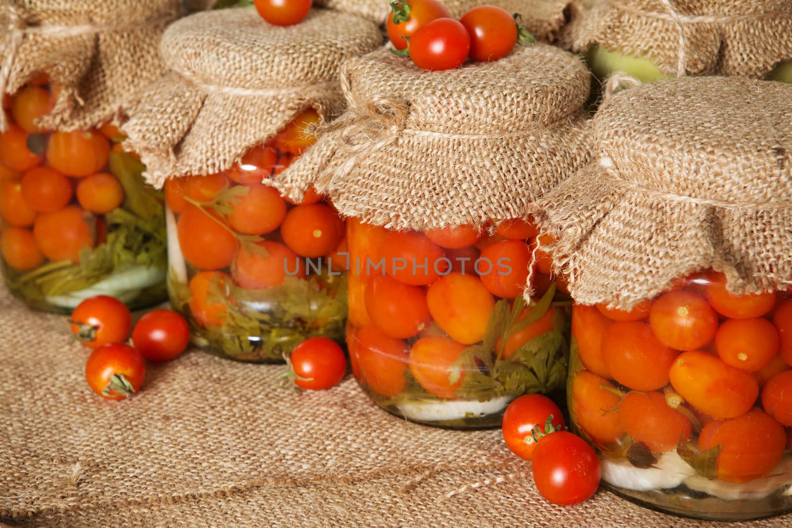 Transparent banks with marinated Cherry tomatoes. Home canning. Banks pickled tomatoes