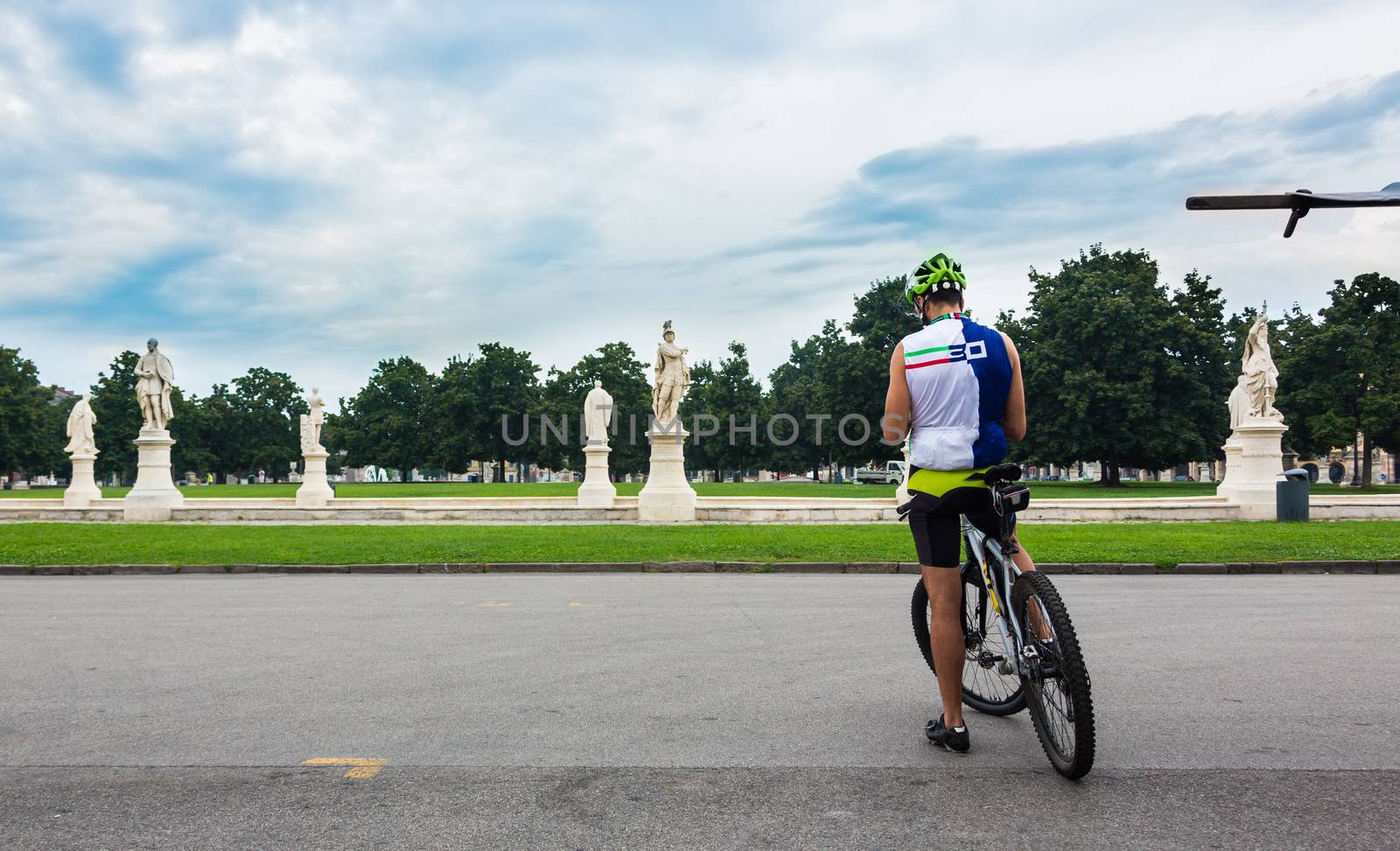 Man on a bicycle.Piazza of Prato della Valle, Padova, Italy.