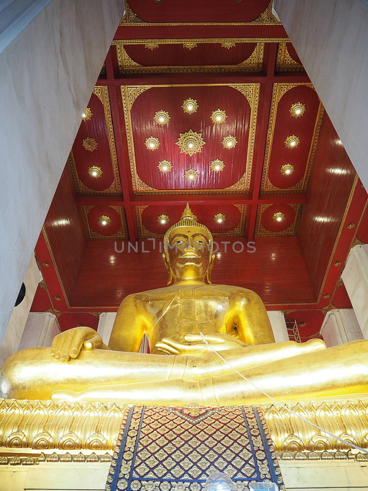 Golden buddha statue indoor in Thailand.