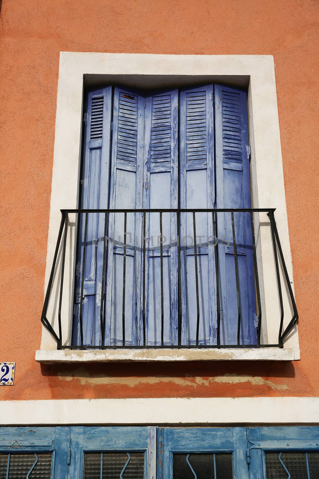 Traditional French Windows With Purple Shutters
