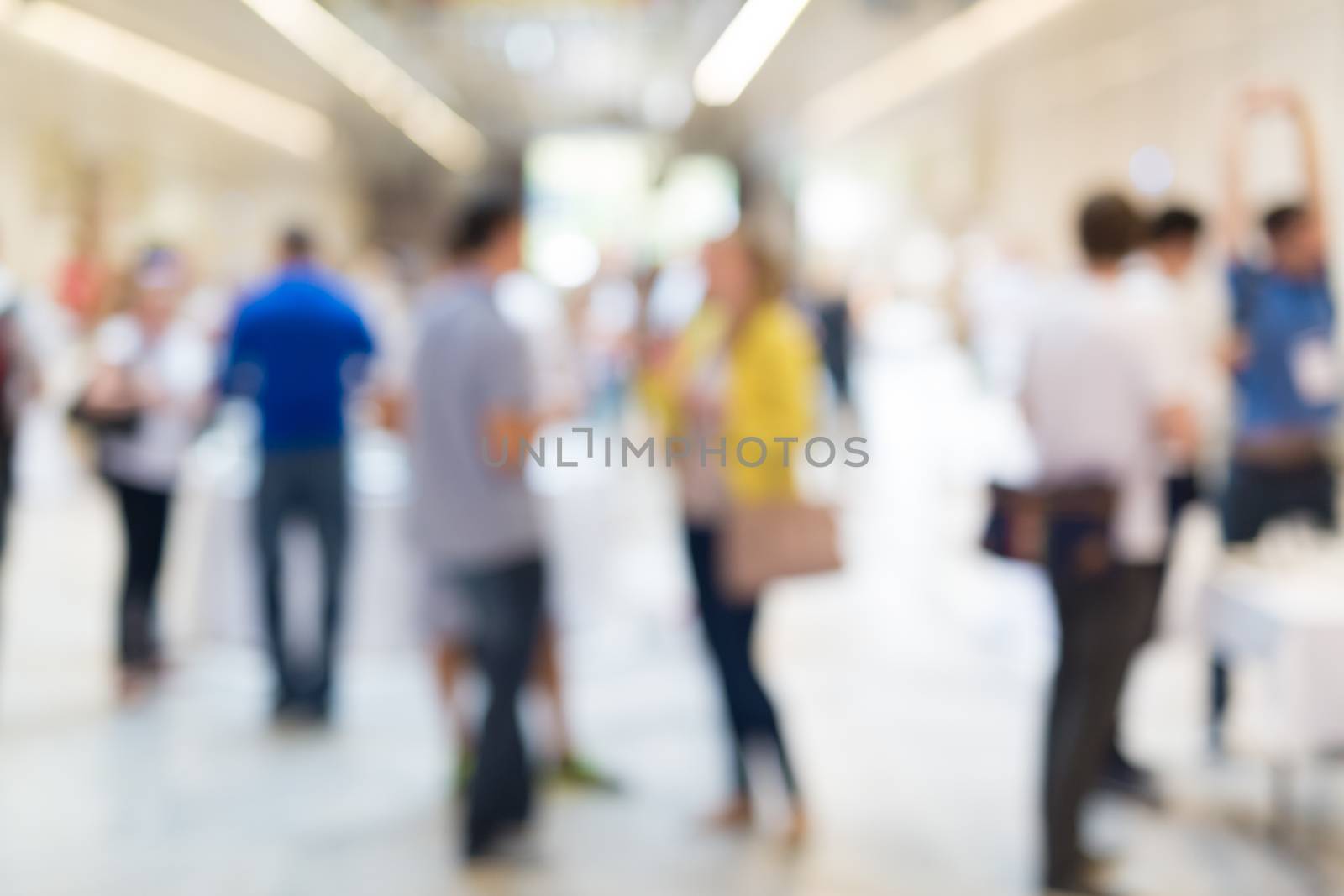 Abstract blurred people socializing during coffee break at business meeting or conference.