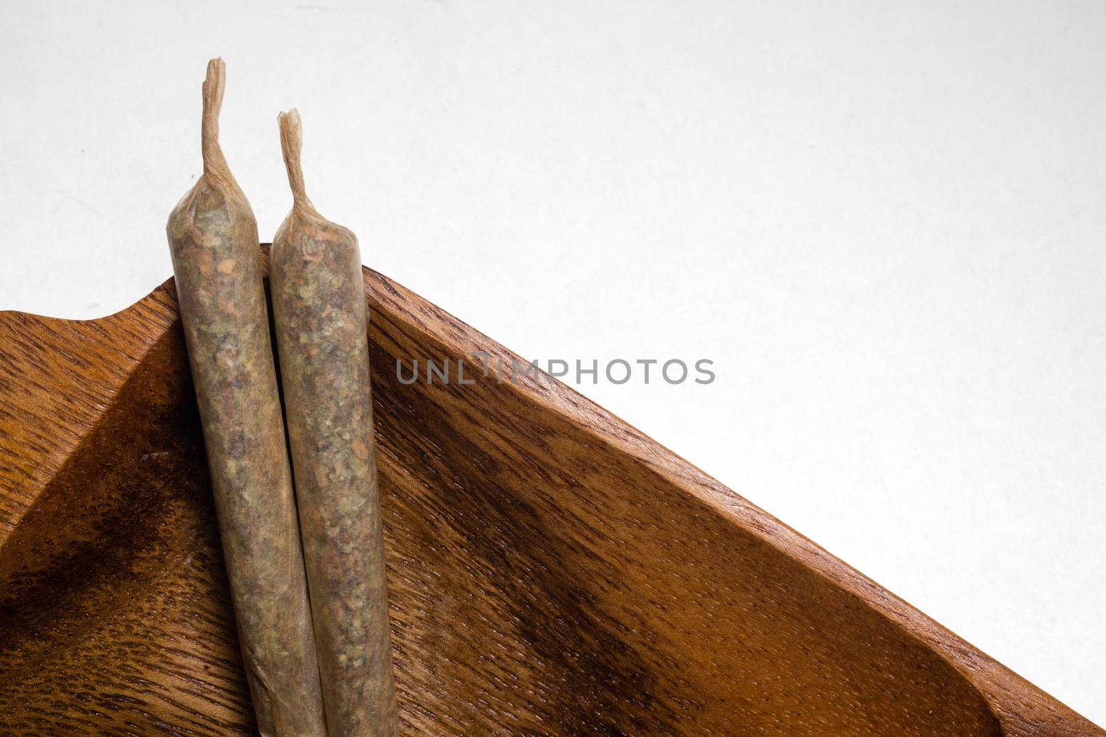 stock of hand made marijuana joints on wooden platter