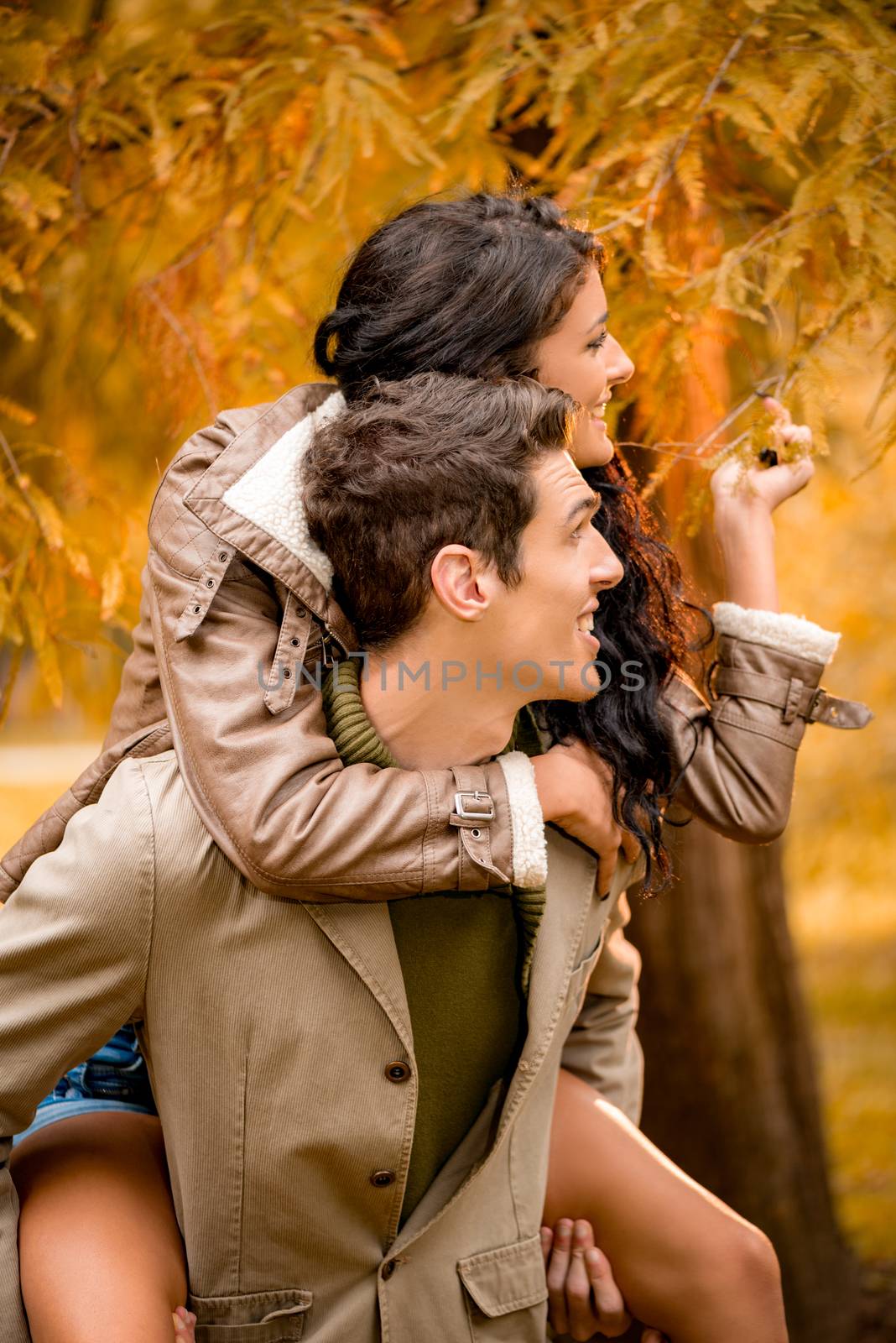 Beautiful young couple enjoying autumn day in the park.