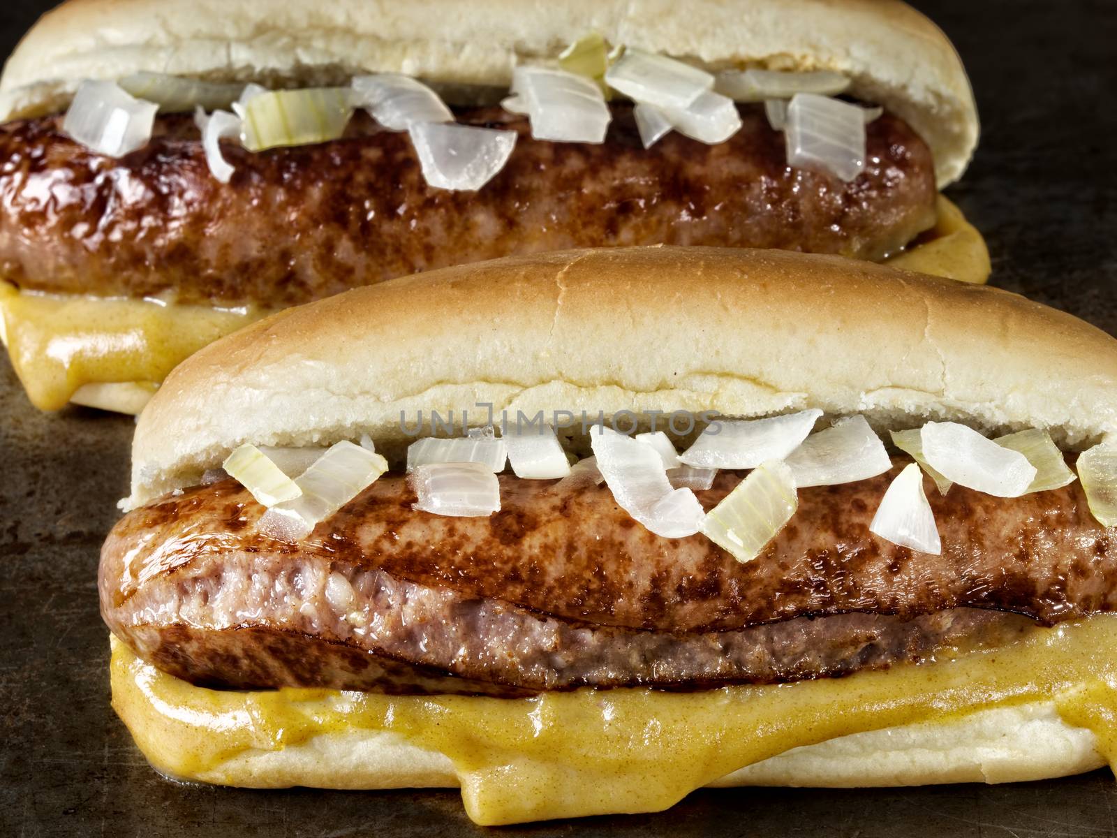 close up of rustic american hot dog with mustard and onion