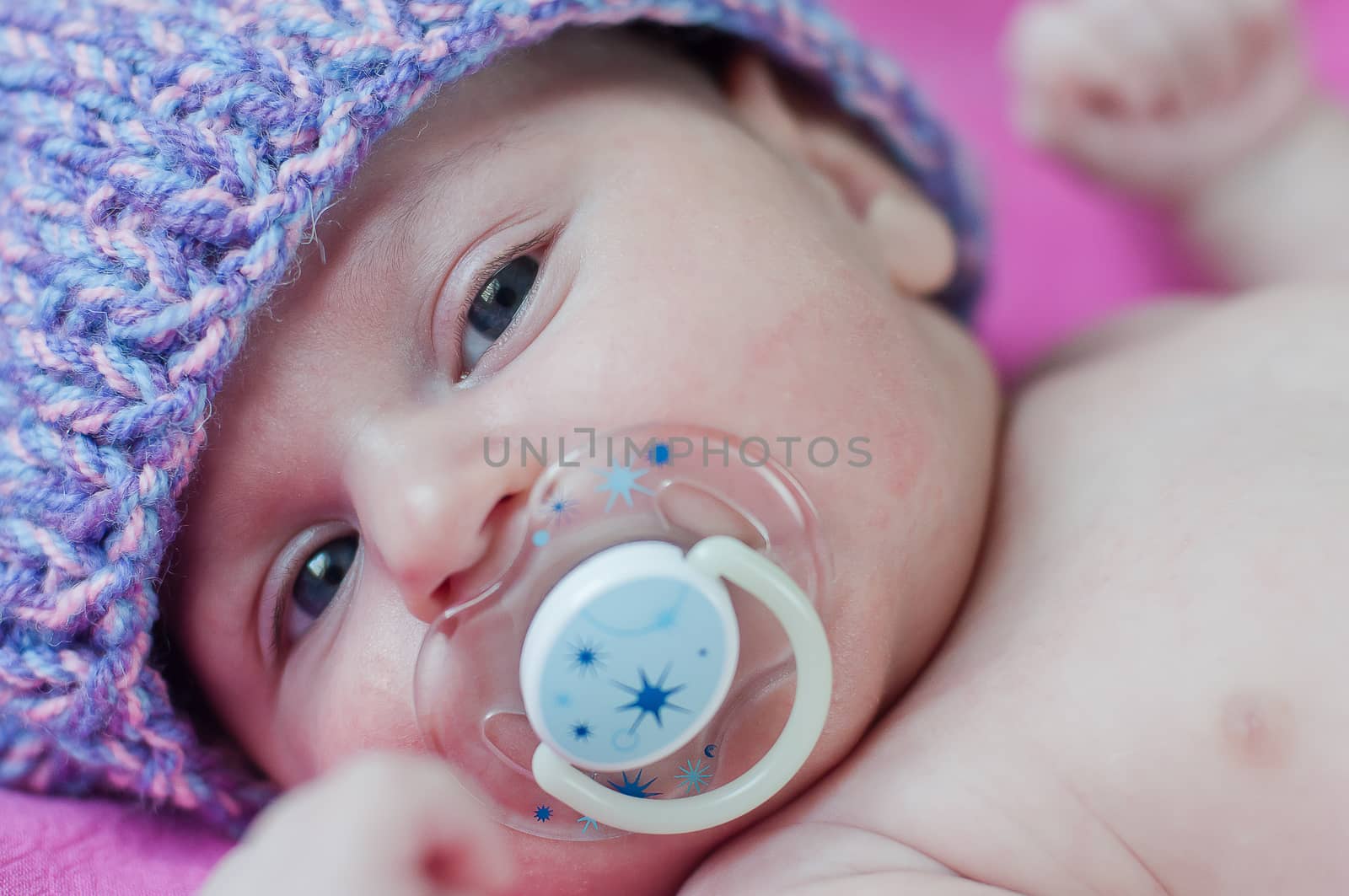 Little baby with soother in hat by Linaga
