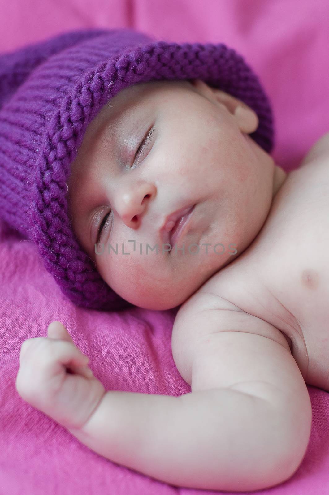 Little baby in hat sleeps peacefully