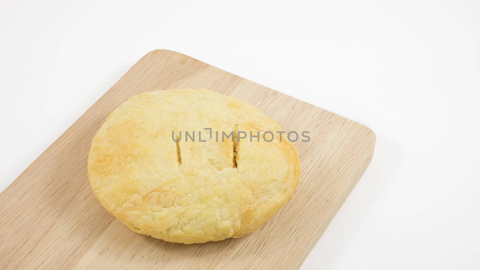 The Taiwanese sun cake (milk butter pastry) on the brown wooden plank.