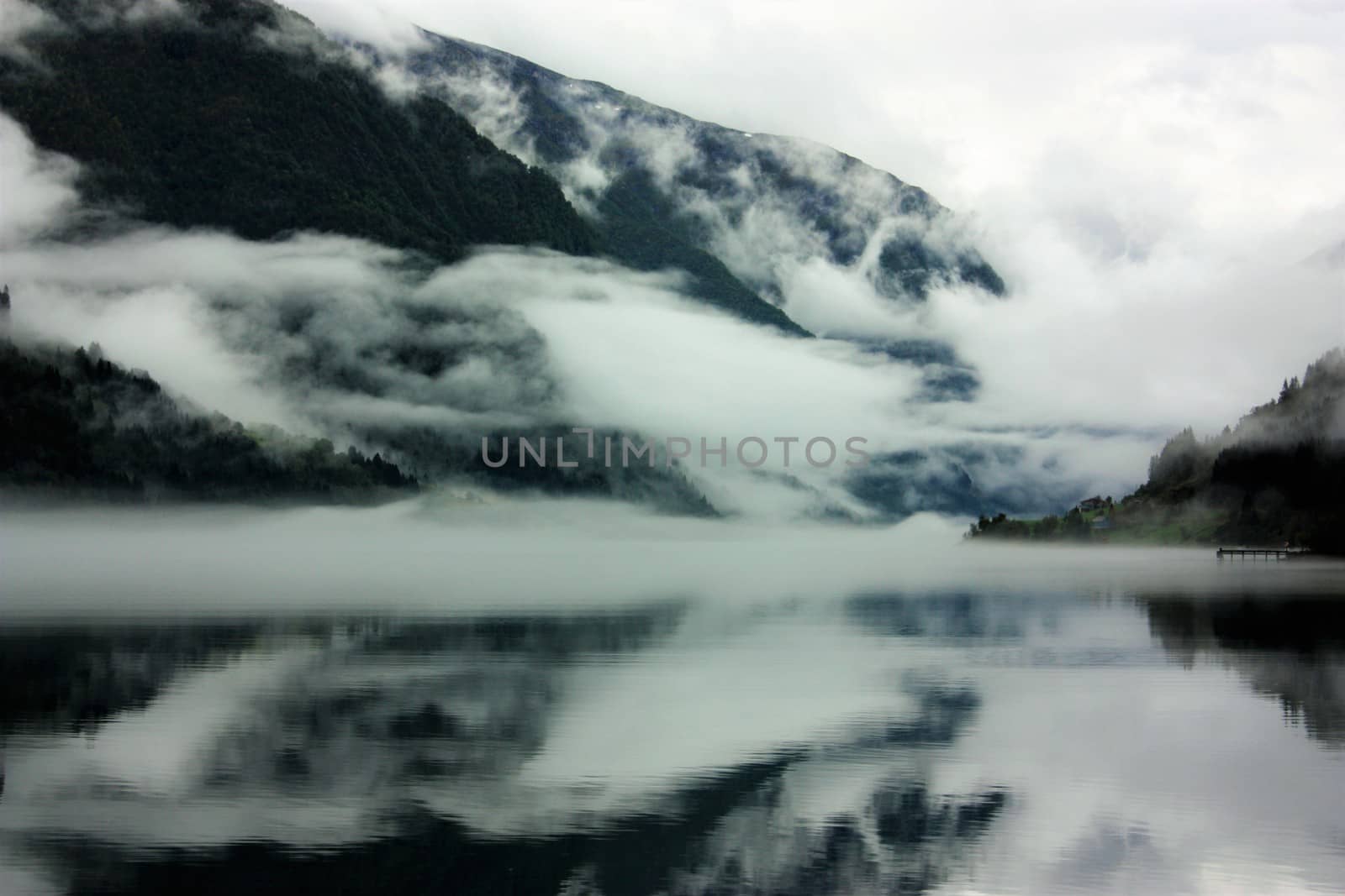 View to a misty Fjærlandsfjord. Fjærland and the sognefjord was among the destinations of early tourism in Norway. One of the famous people who visited Fjærland in de early 1900s was Kaiser Wilhelm of Germany.