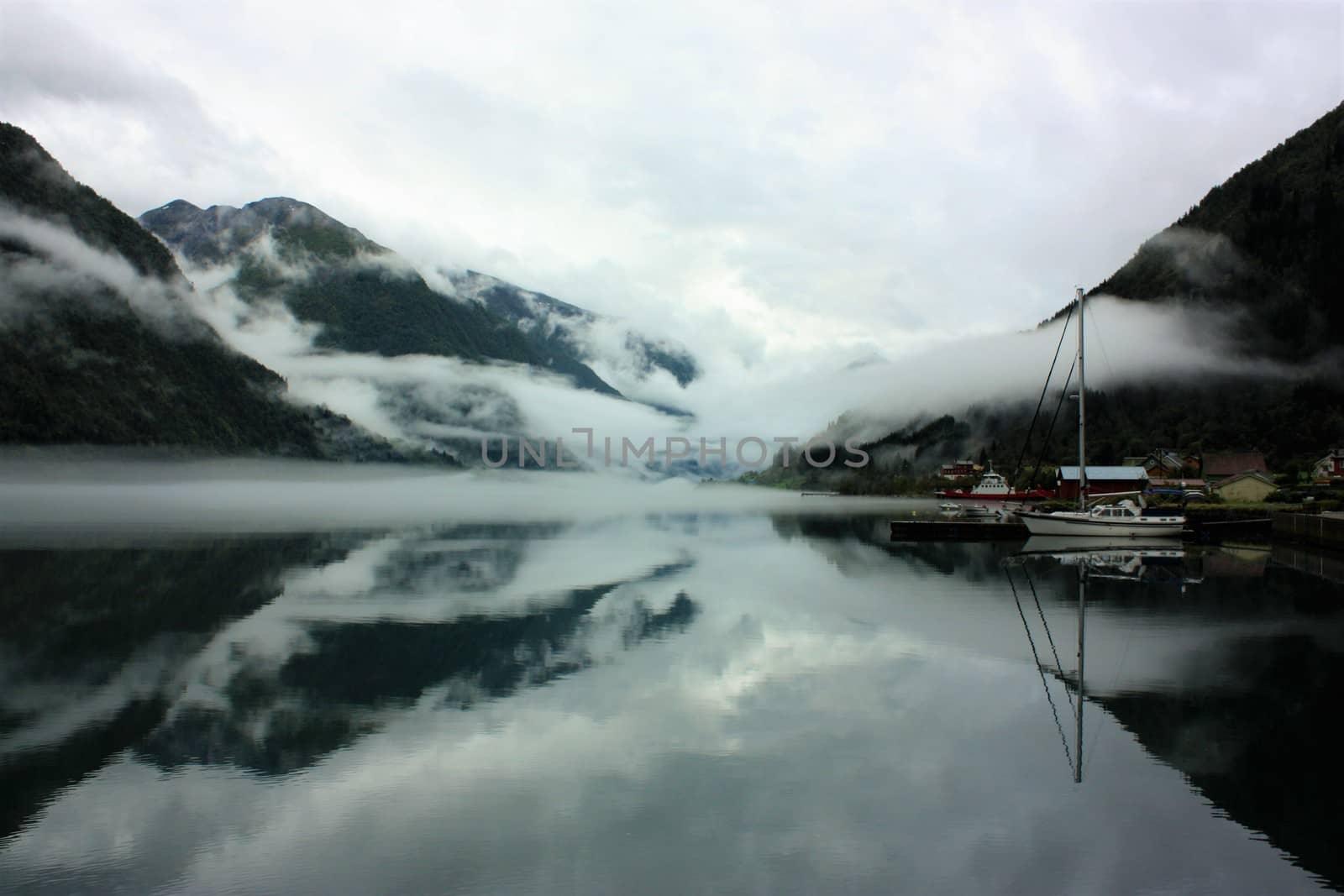 View to a misty Fjærlandsfjord. Fjærland and the sognefjord was among the destinations of early tourism in Norway. One of the famous people who visited Fjærland in de early 1900s was Kaiser Wilhelm of Germany.