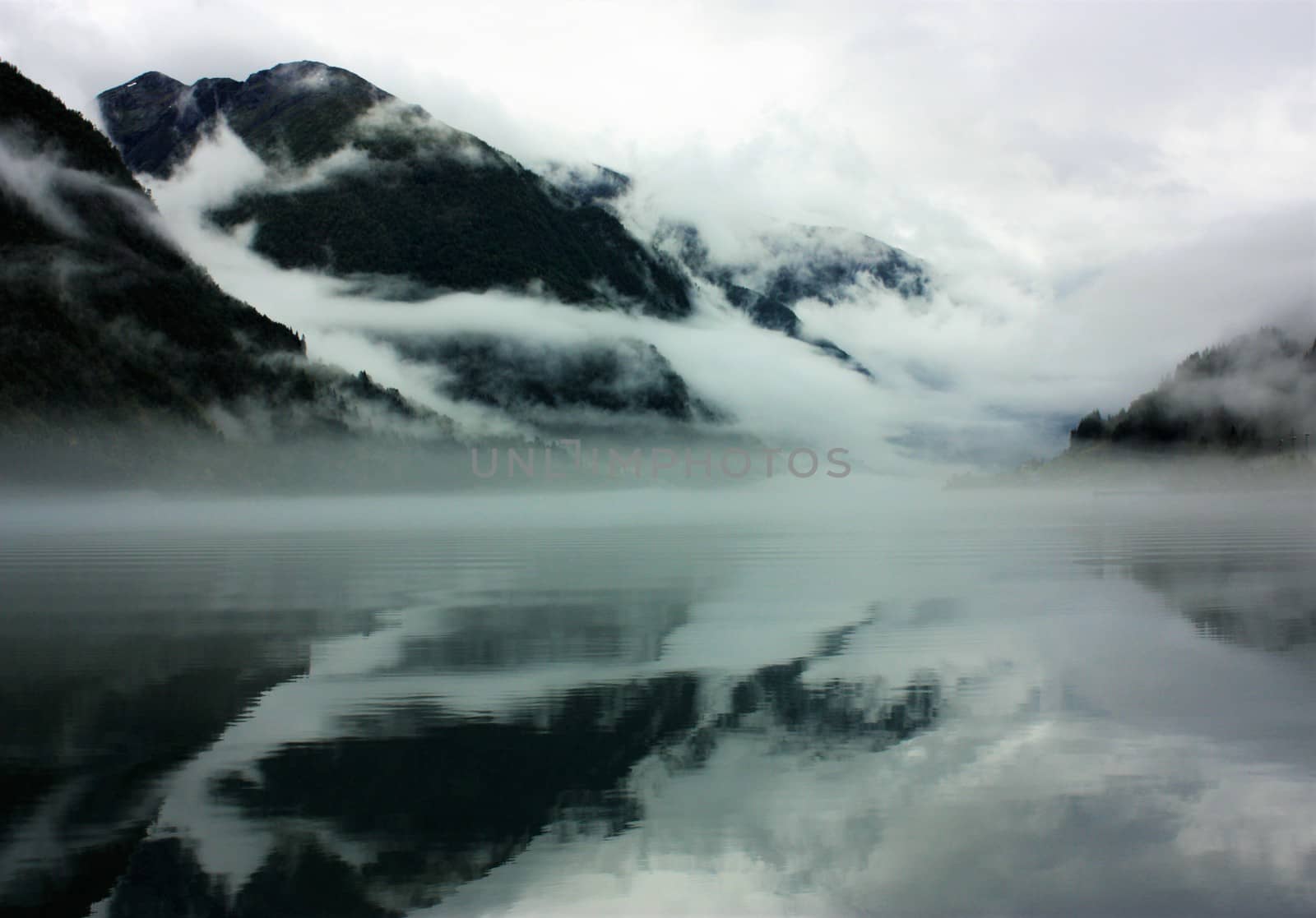 View to a misty Fjærlandsfjord. Fjærland and the sognefjord was among the destinations of early tourism in Norway. One of the famous people who visited Fjærland in de early 1900s was Kaiser Wilhelm of Germany.