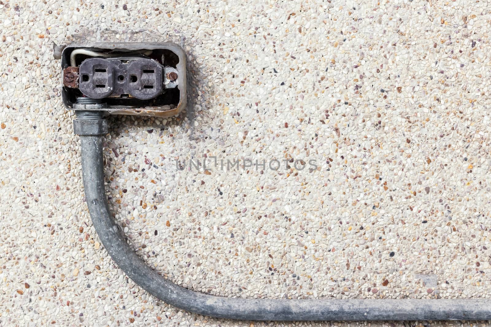 Asia plug socket on brick wall background. Risk of danger.