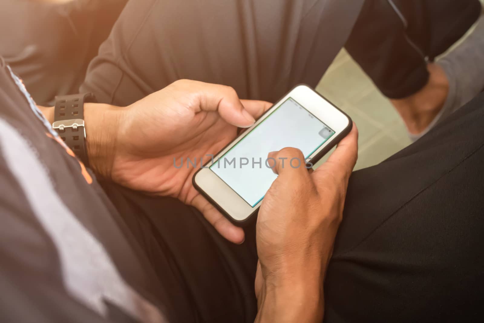 Man using smartphone for play game or online social network by nopparats