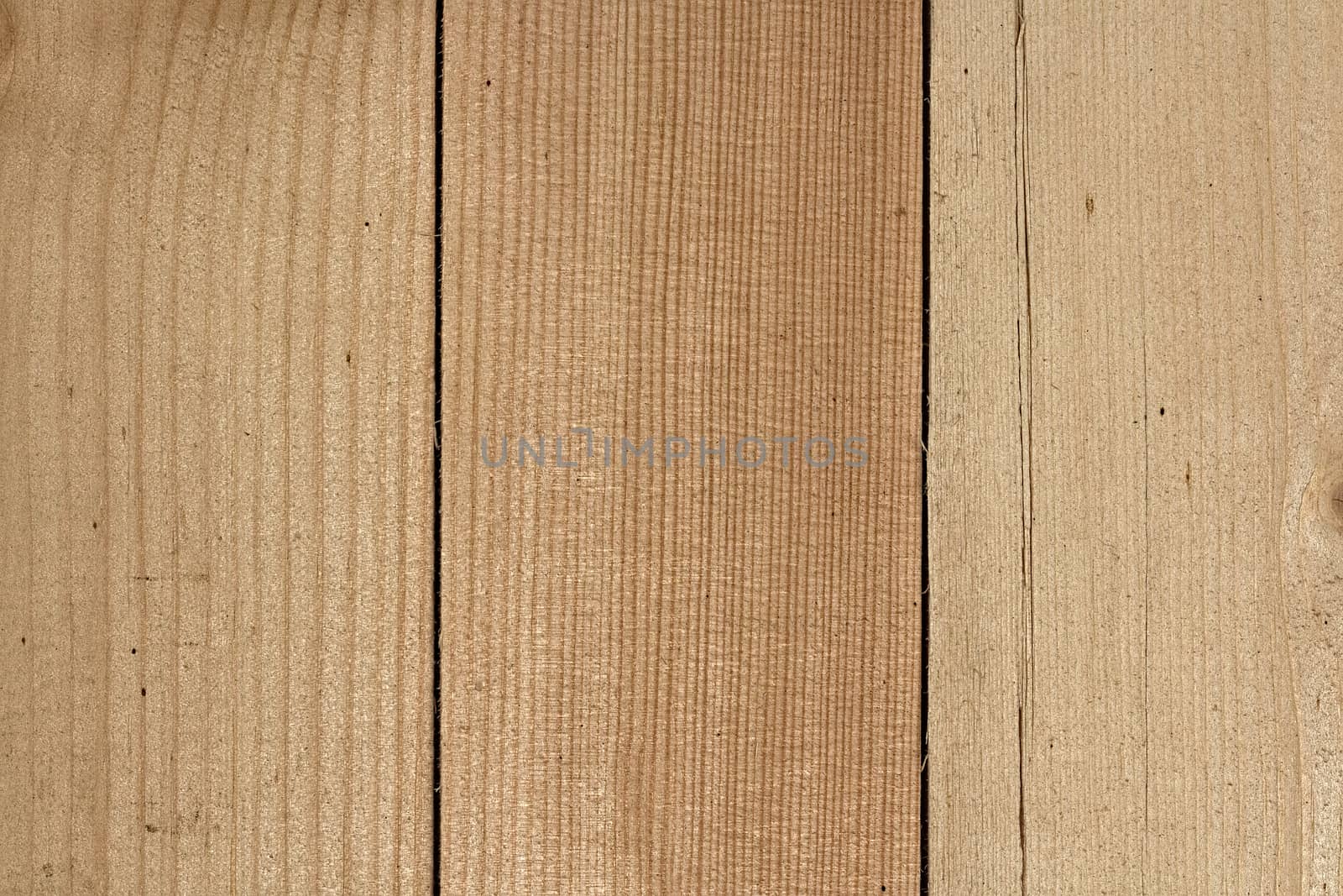 Three close lying pine boards. The texture of natural wood. Wooden background for posters, banners, web design. Close up image