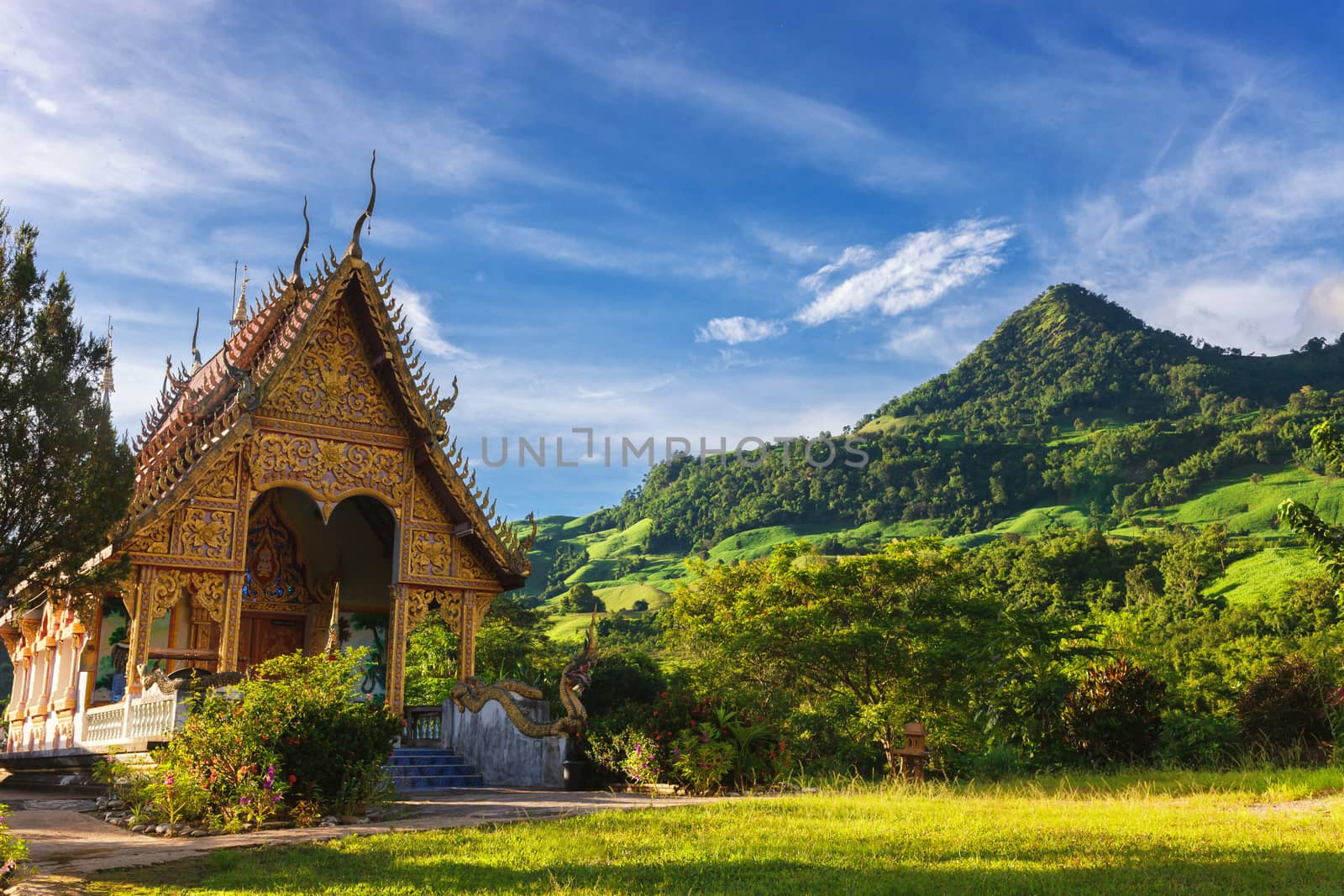 Temple in thailand near mountain valley during sunrise. Natural summer landscape.