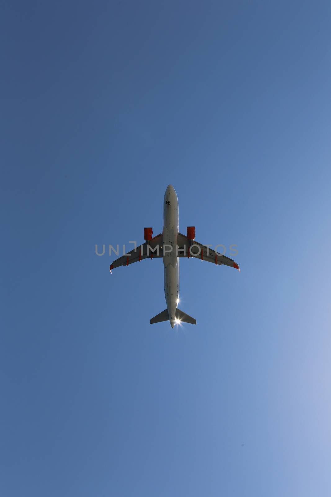 Silhouette of airplane flying over the blue skies