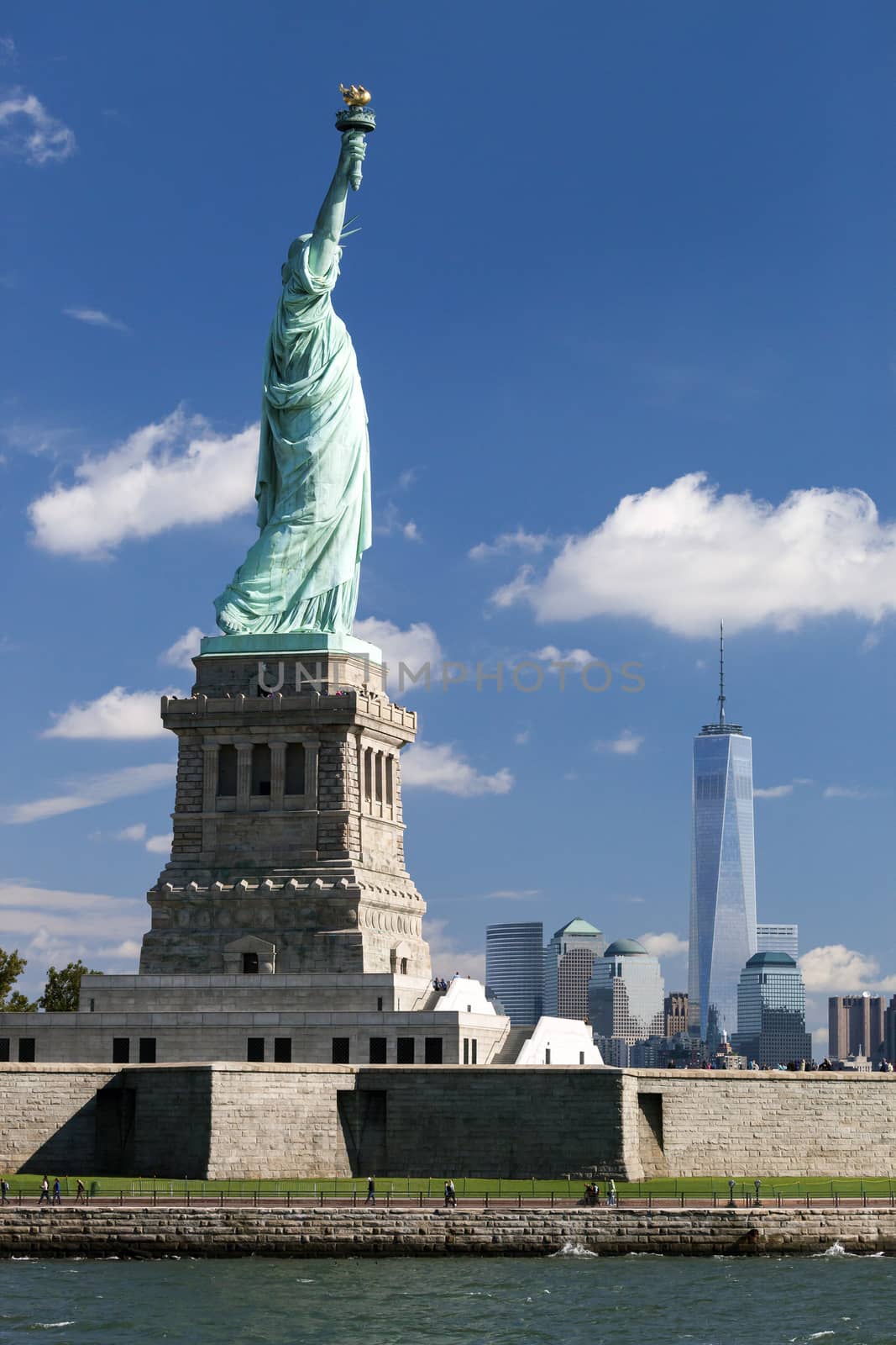 The Statue of Liberty at New York City with the Freedom Tower