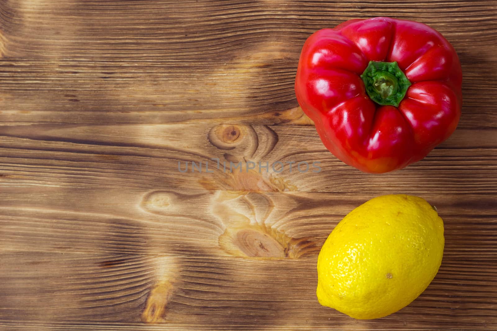 Vegetable wooden background for postcard with red pepper and yellow lemon