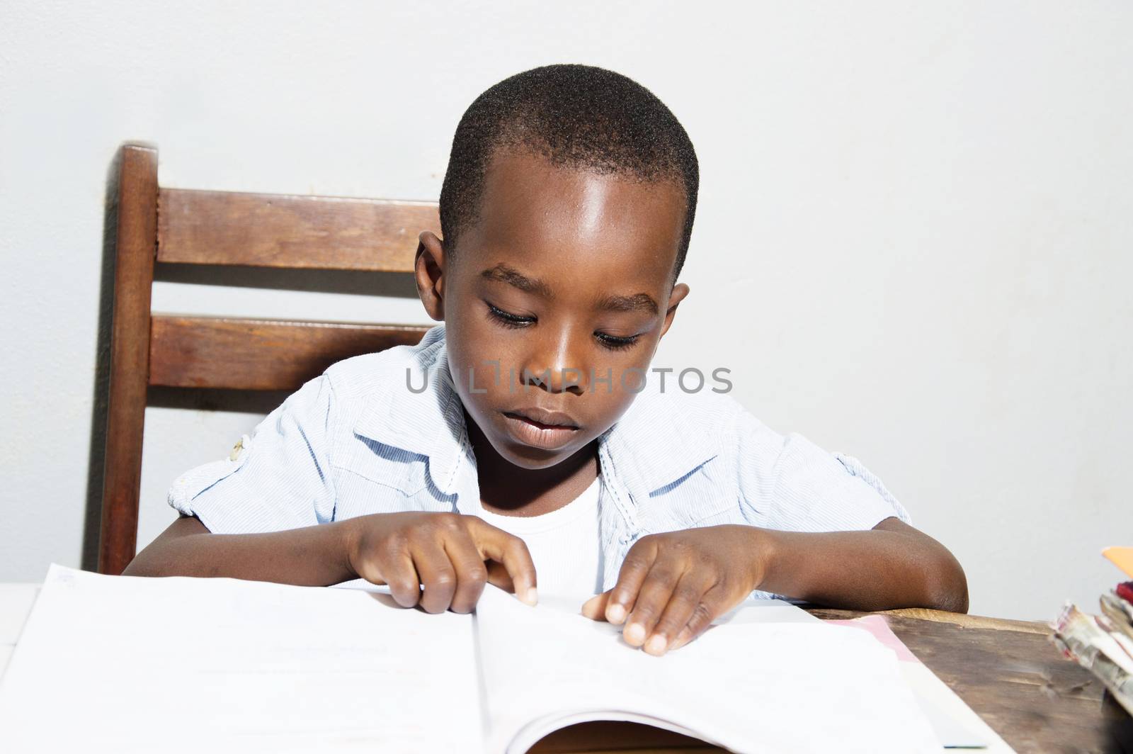 The student learns to read at night at home