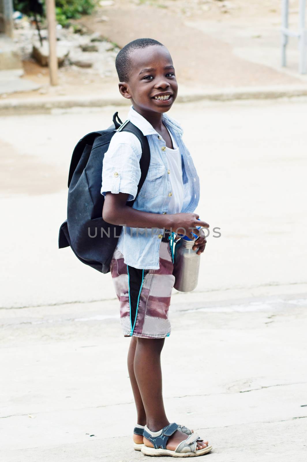 This schoolboy is happy to go to school.