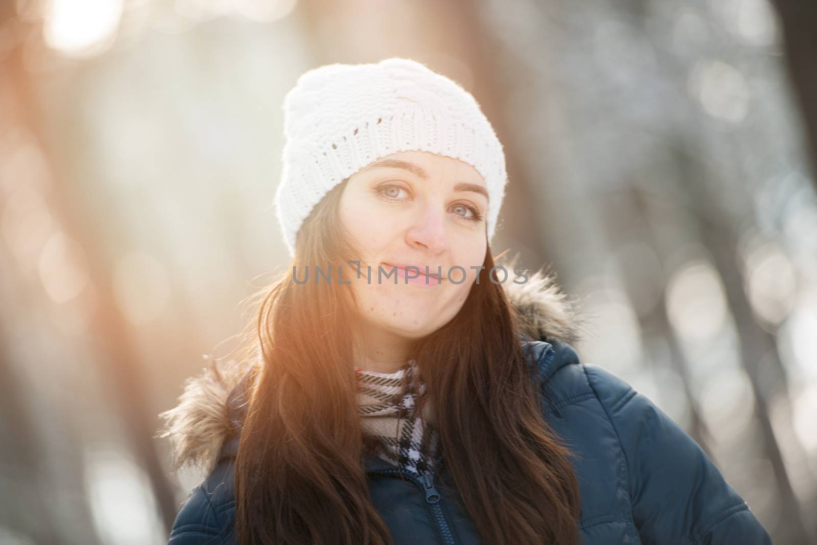 An image of young woman on a walk in snowy winter