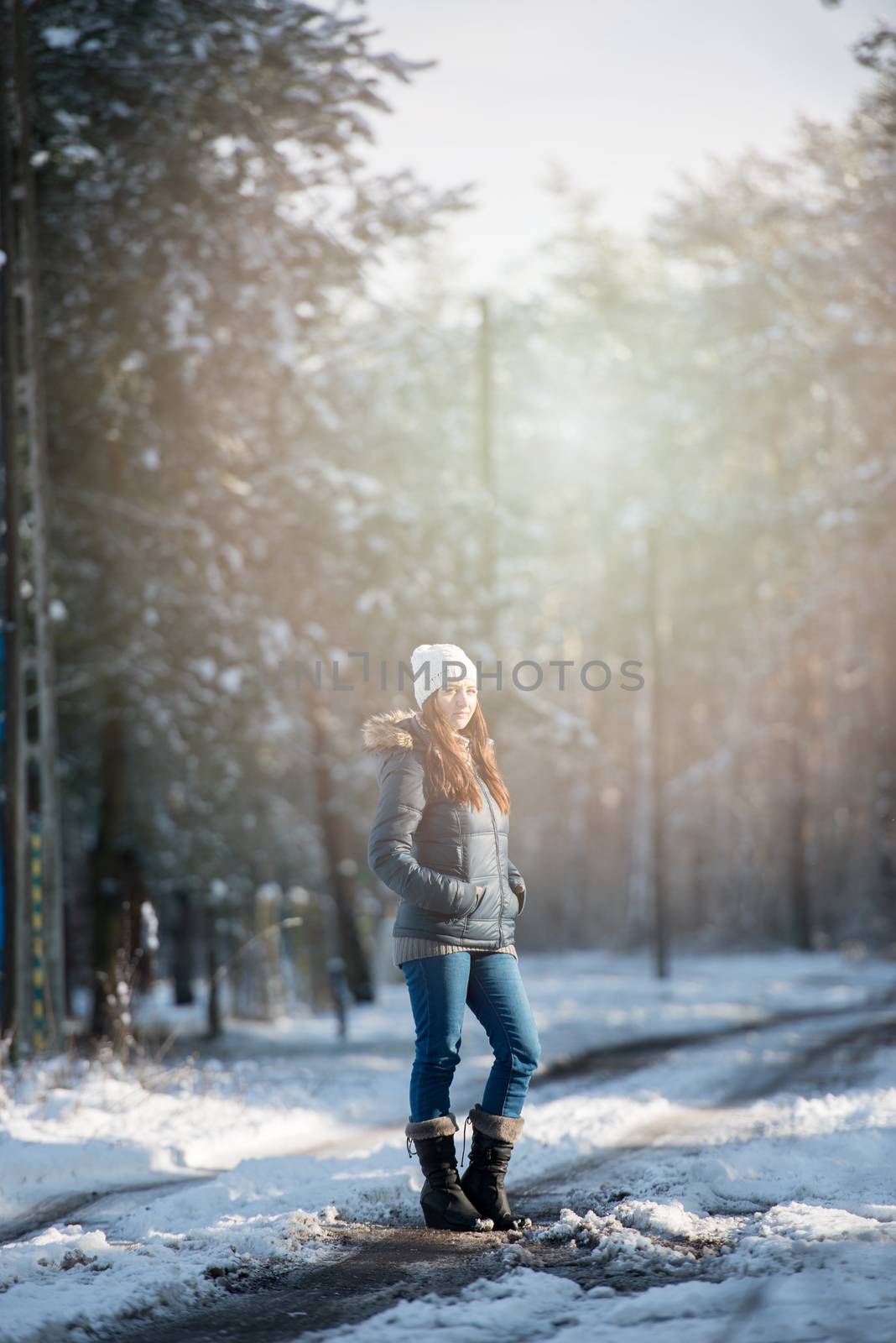 Young woman on a walk in snowy winter by Brejeq