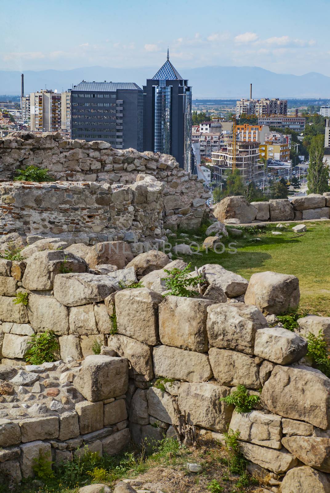 View of Plovdiv, Bulgaria downtown with ancient ruins in foreground.